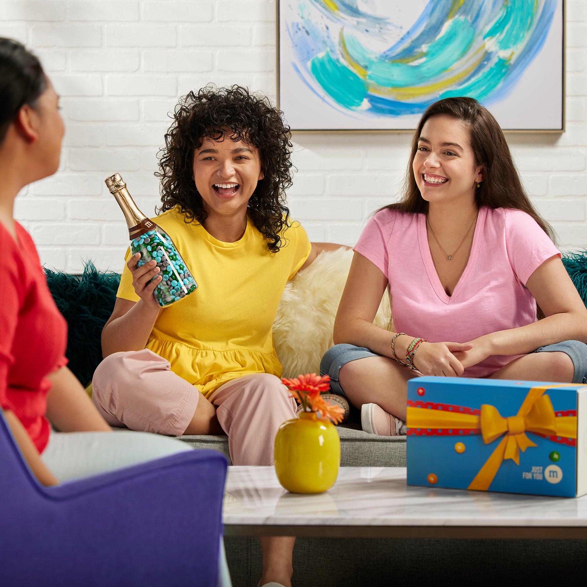 friends gathered around a couch celebrating