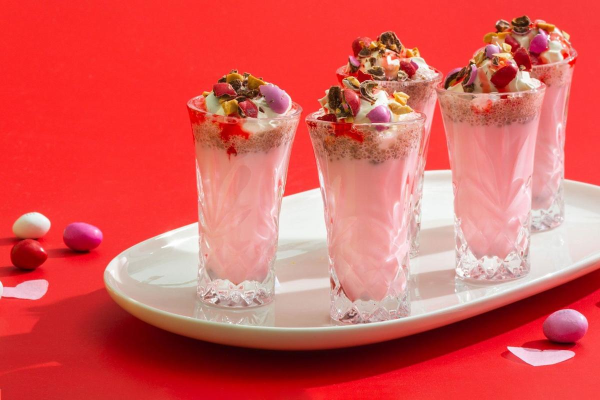 strawberry and peanut butter milkshakes in glasses on a serving tray