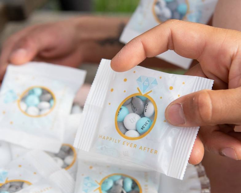 Wedding ring favor packs with hands grabbing for them