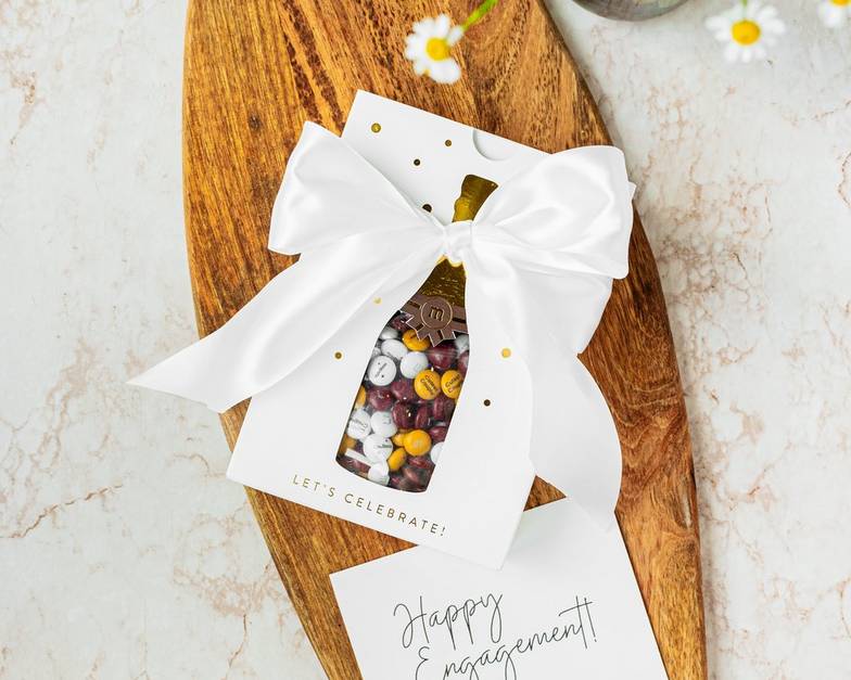 gift box on table with card for "Happy Engagement"