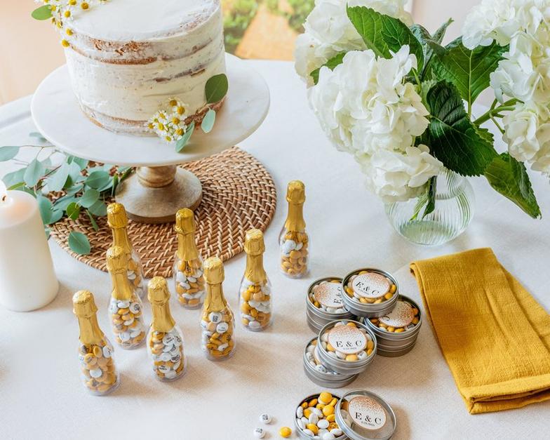 Assorted favors on a table with wedding cake