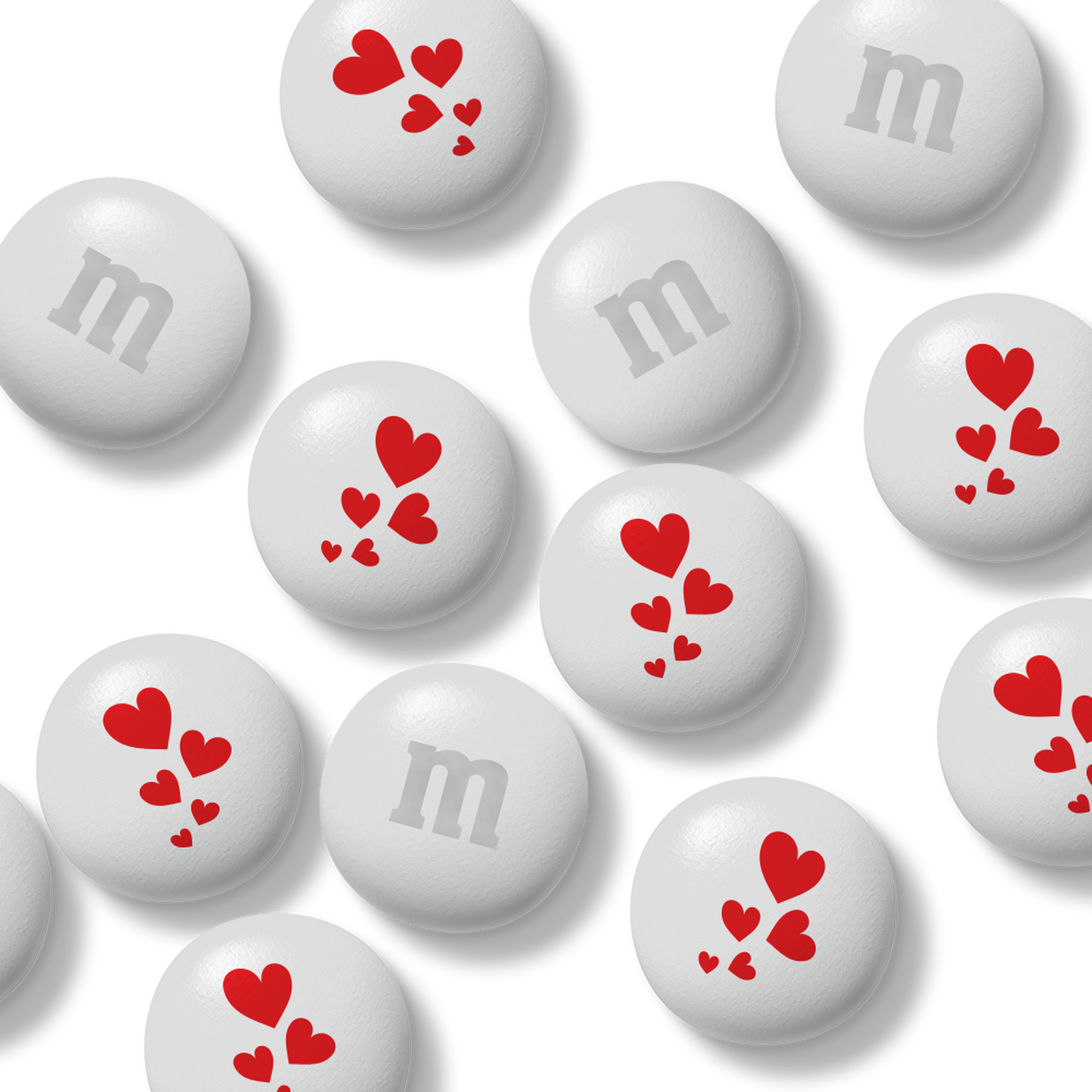 Bag of M&M'S chocolate candies, 32 oz, white with red snowflake pattern, held in a hand.