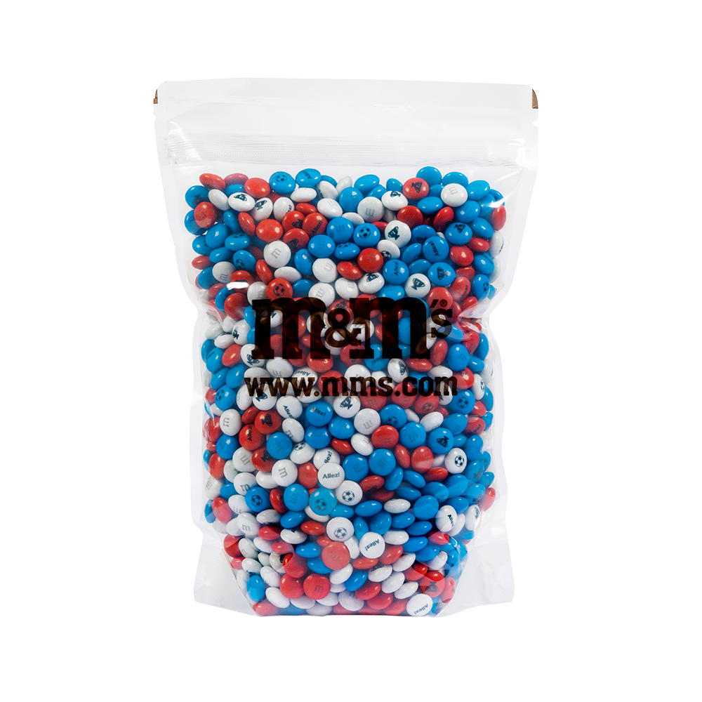 Bolsa transparente de dulces de chocolate M&M'S en colores rojo, blanco y azul, con el logo M&M'S y www.mms.com impresos.