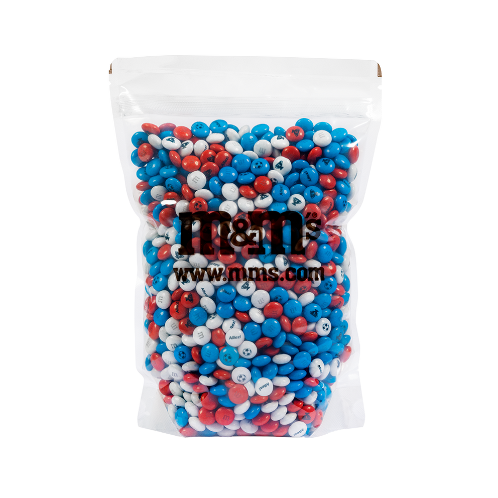 Bolsa transparente de dulces de chocolate M&M'S en colores rojo, blanco y azul, con el logo M&M'S y www.mms.com impresos.