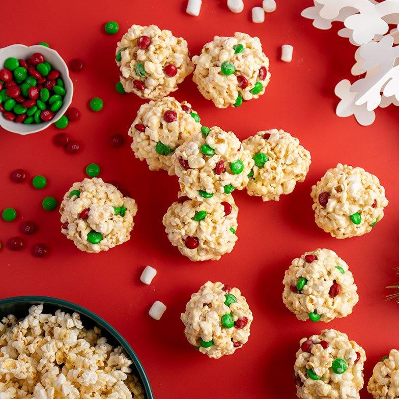 holiday popcorn balls on table with green & red M&M'S