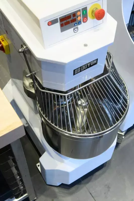 Doyon industrial mixer with control panel and wire guard over mixing bowl.