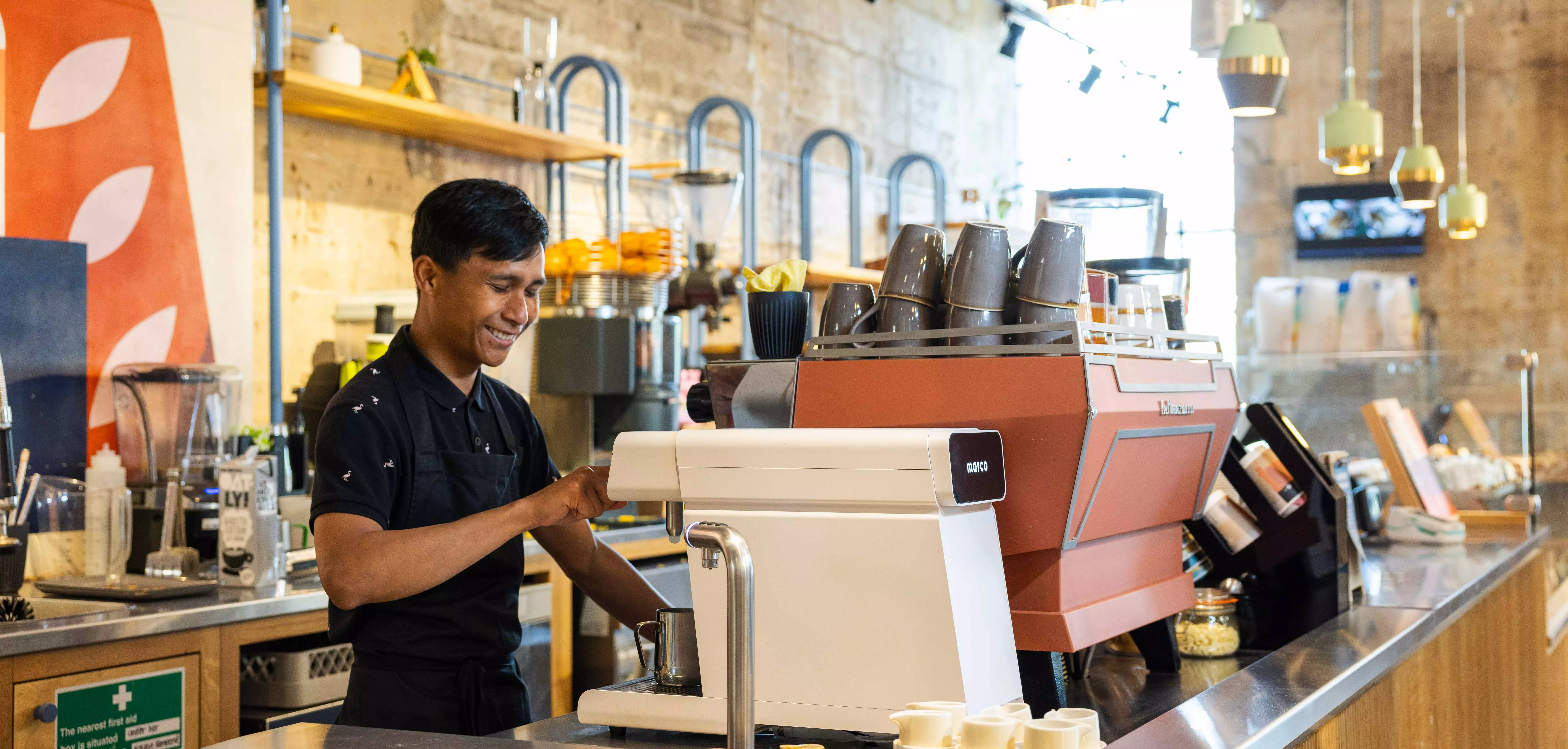 A photo showing a cafe where automated, controlled commercial beverage systems help improve throughput