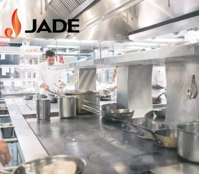 Chef working in a professional kitchen with JADE branding visible.