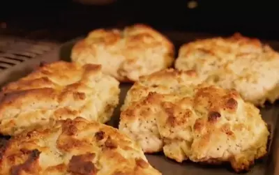 Baked biscuits on a tray, golden brown and crispy.