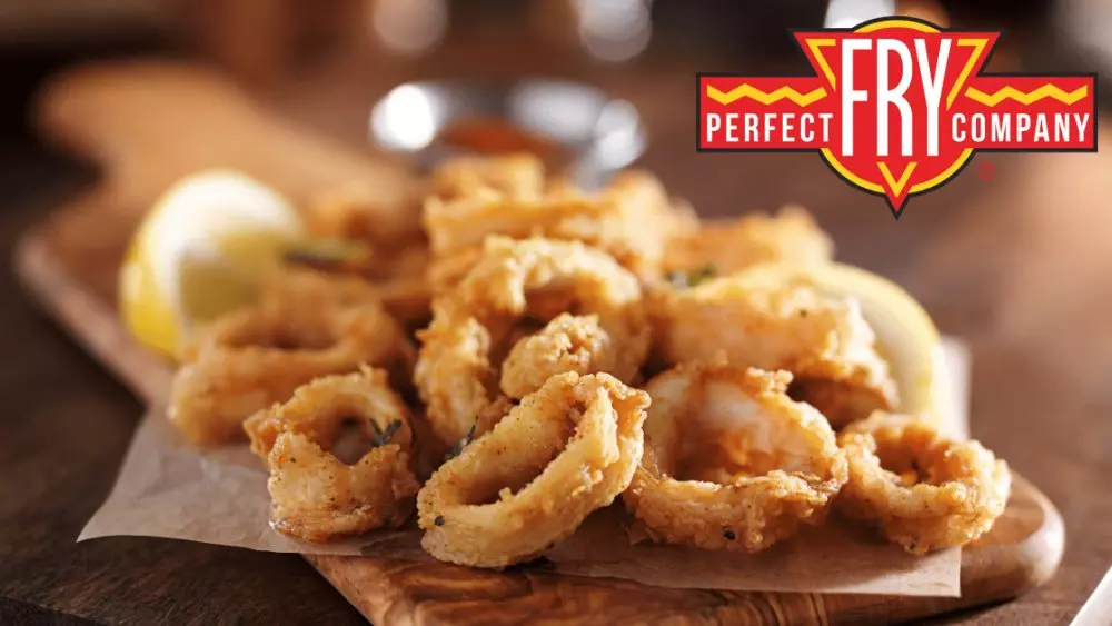 Fried calamari on a wooden board with lemon. Perfect Fry Company logo displayed.