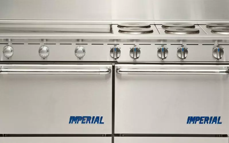 Stainless steel Imperial stove with six control knobs and oven doors.