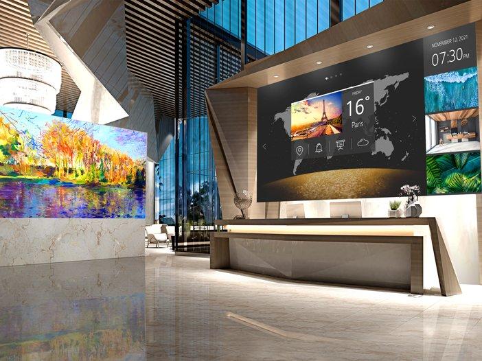 a lobby with a large painting on the wall and a large screen