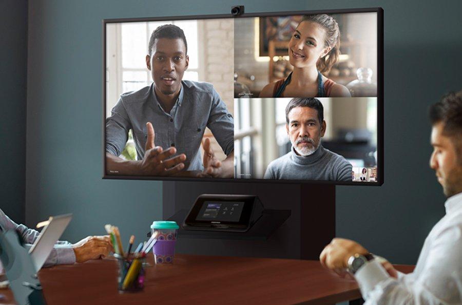 a large conference room with a large screen showing a city