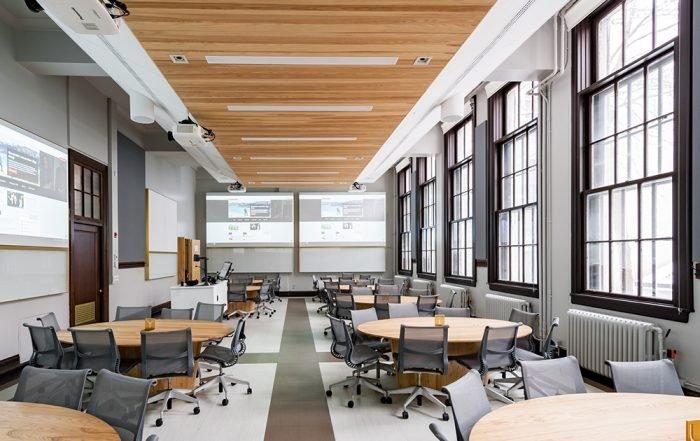 a large room with tables and chairs and a large window