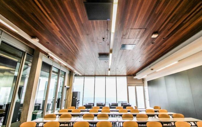 a classroom with a large table and chairs and a large window
