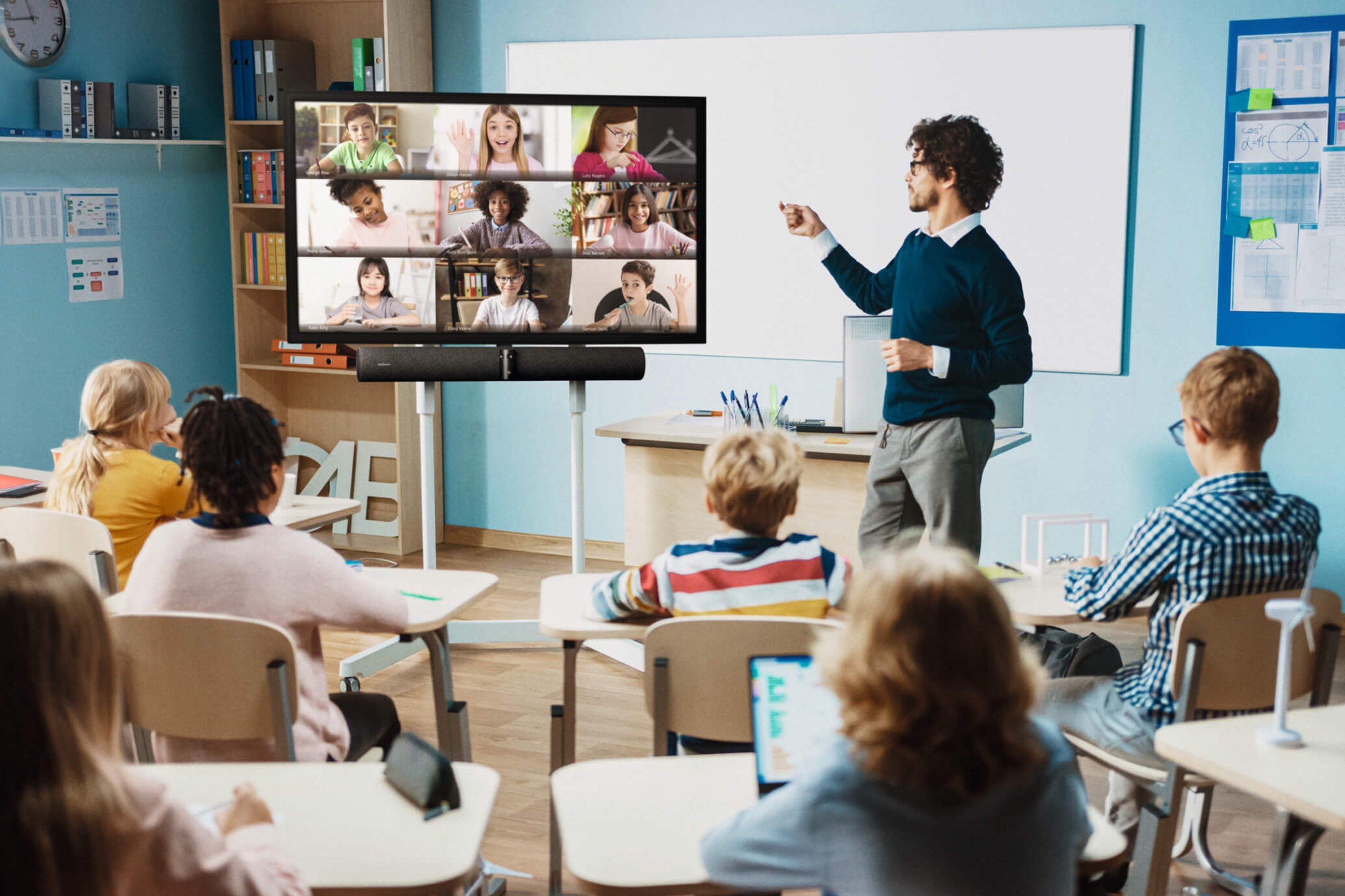 a group of children sitting at desks in a classroom