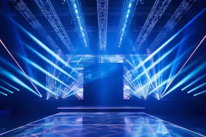 a stage with blue lights and a platform