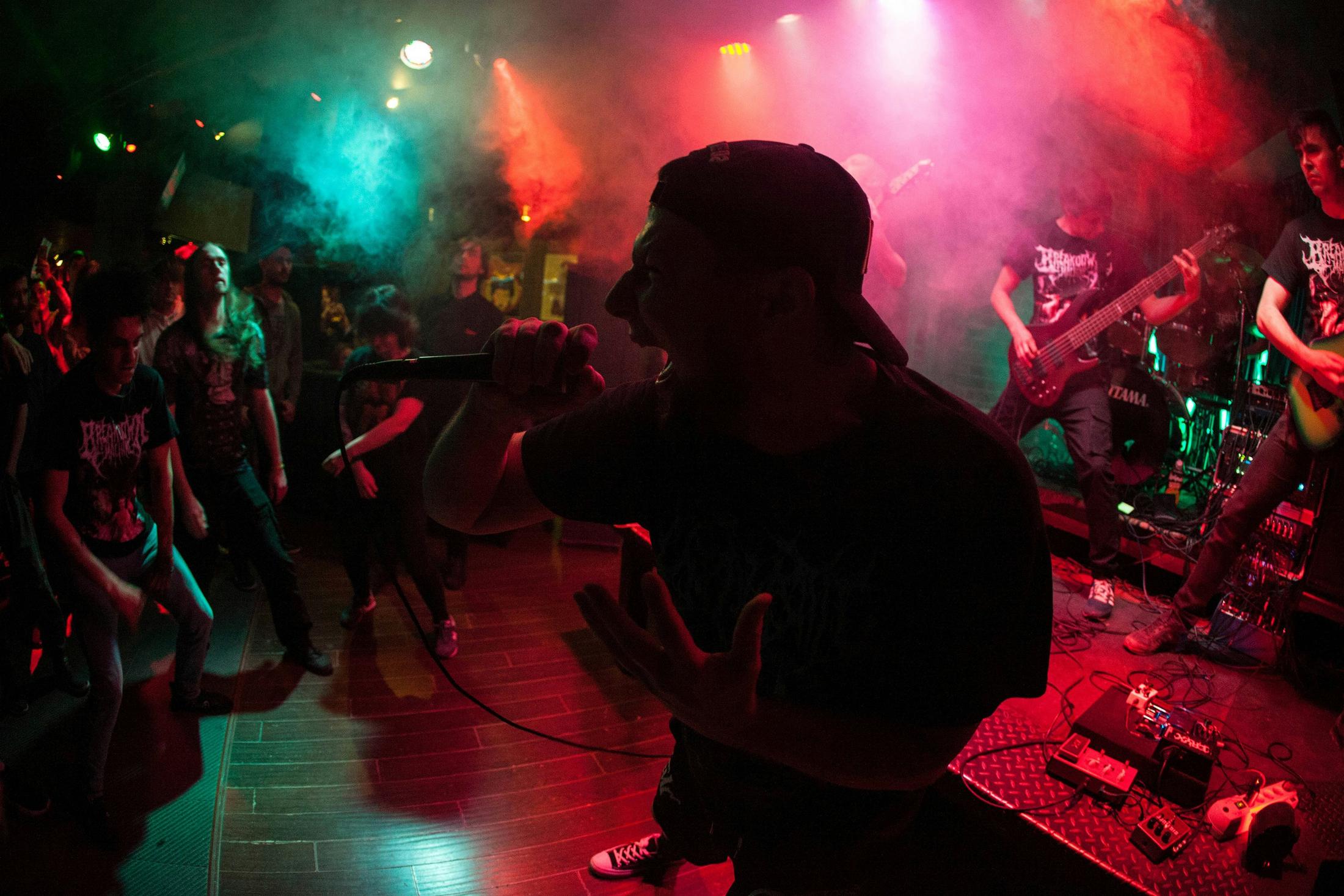 a band performing on stage with smoke and lights