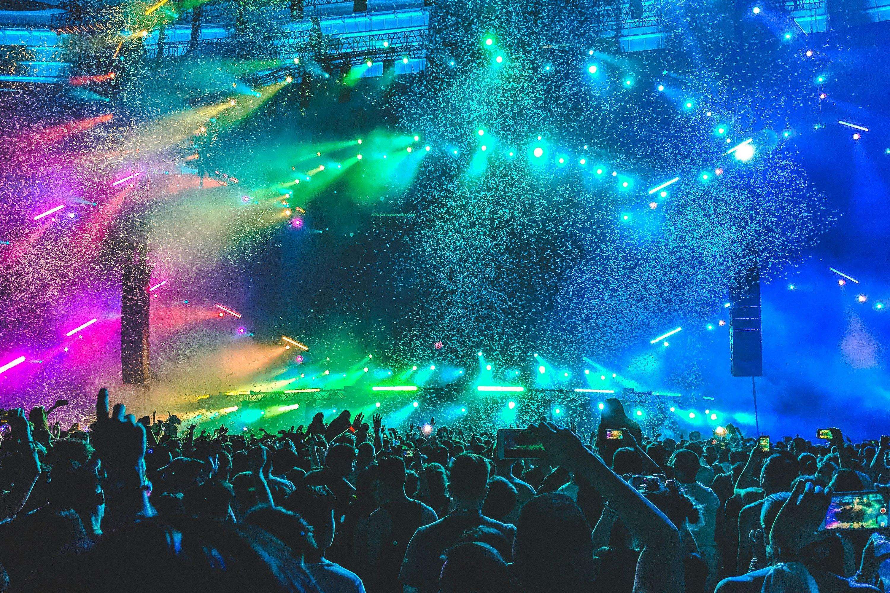 people sitting in a church pew with a stained glass window in the background