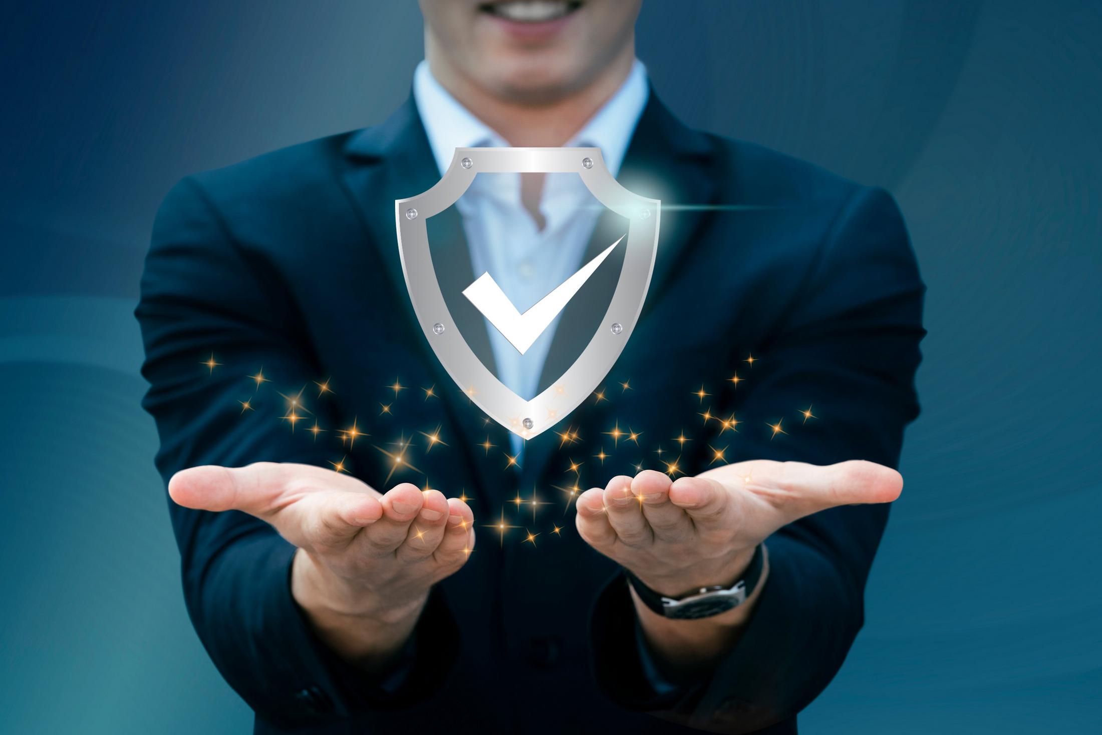 a man in a suit holding a shield with a check mark