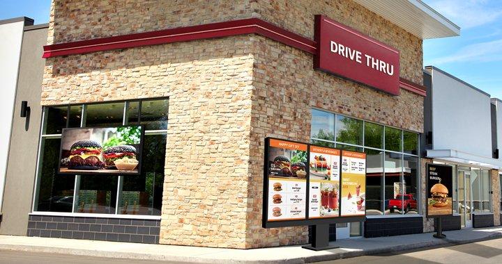 a drive thru restaurant with a drive thru window and a drive thru sign