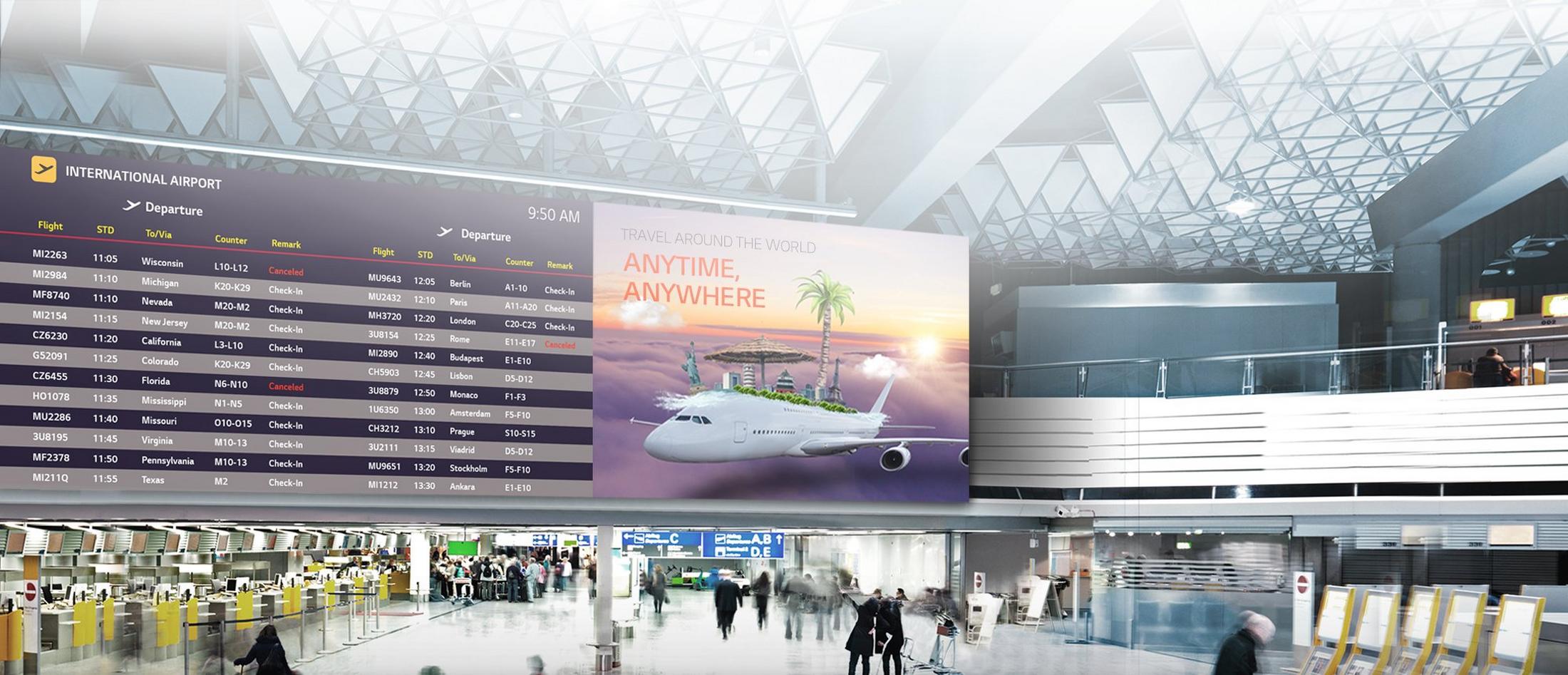 a large group of people standing in a large airport terminal