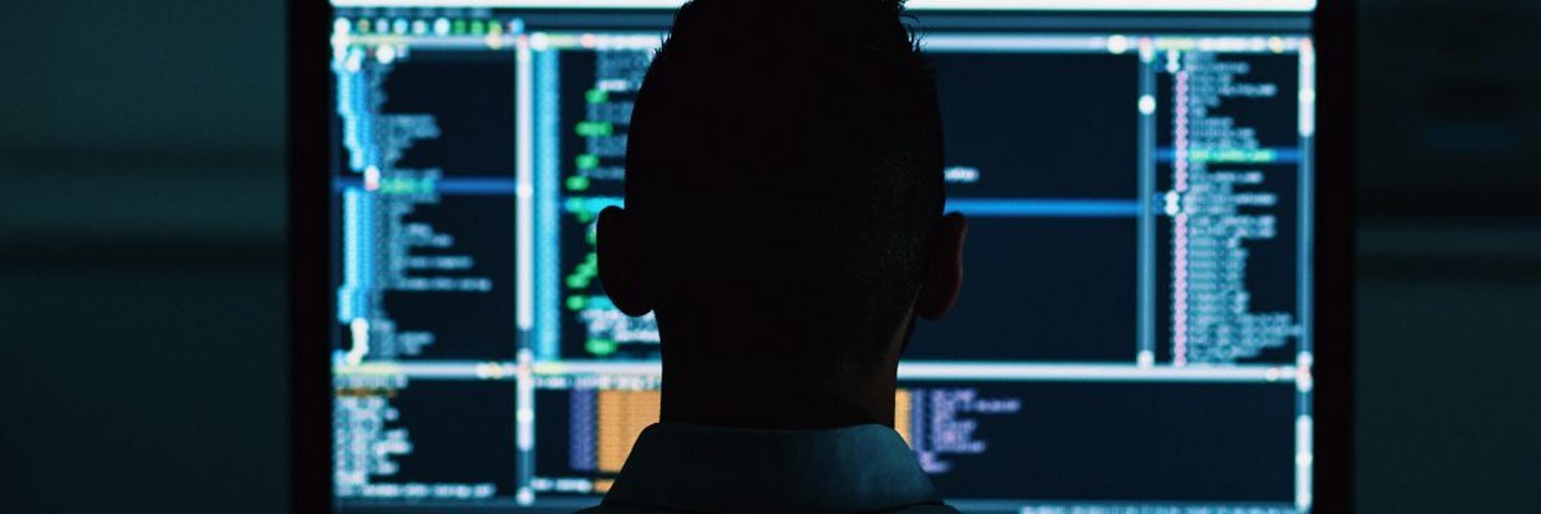 a man in a suit looking at a computer screen