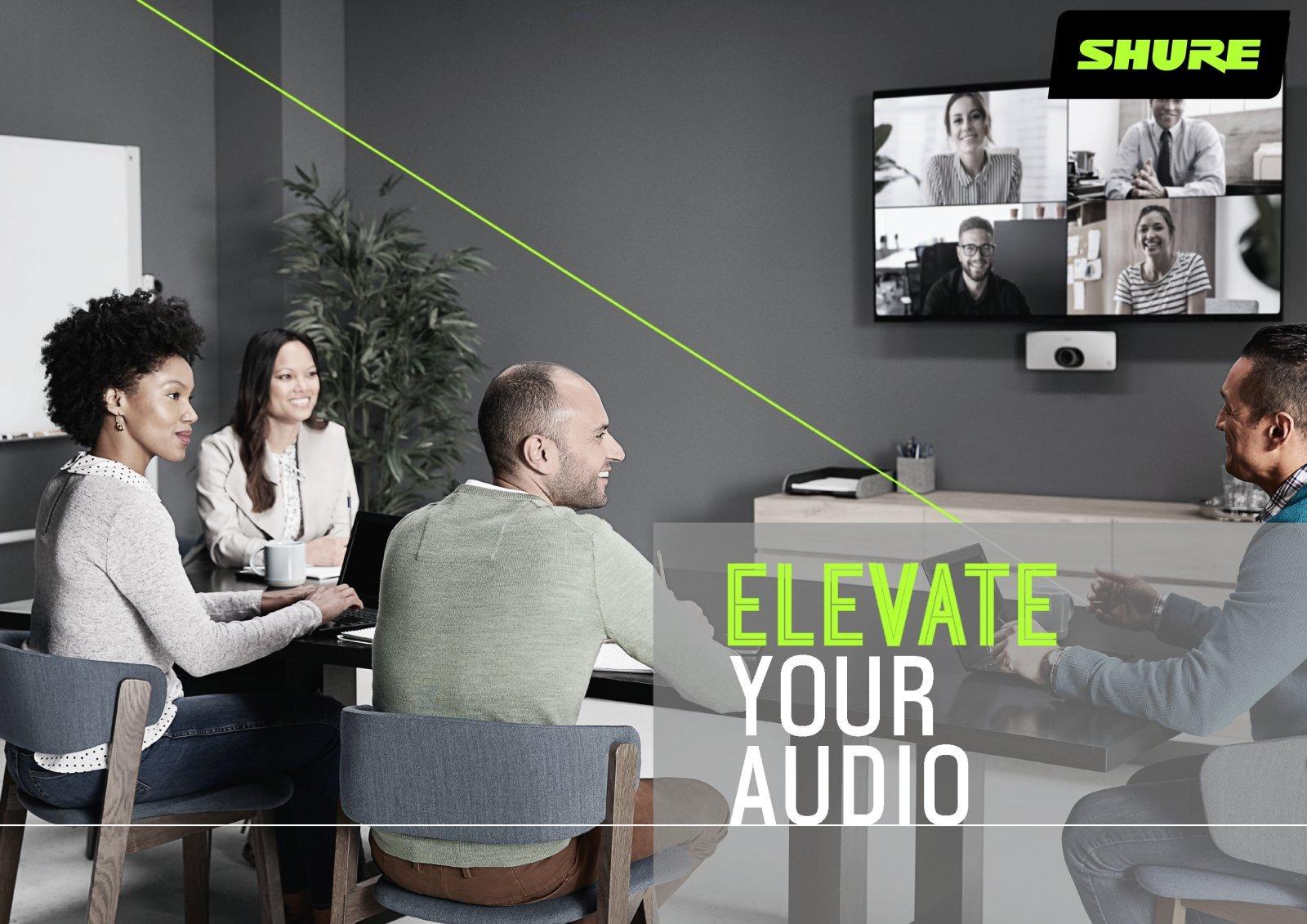 a group of people sitting around a table with a projector