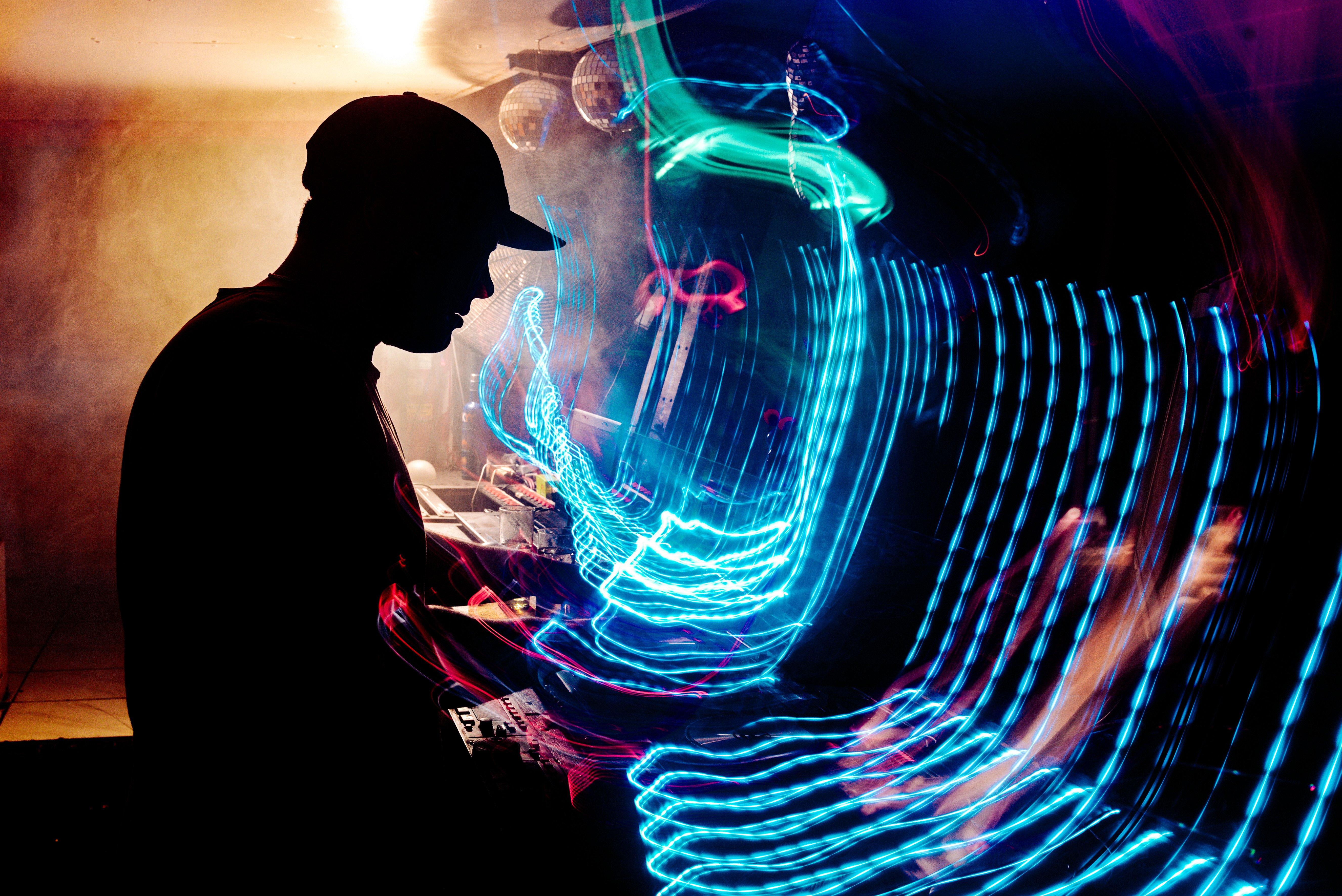a man is playing a keyboard in a dark room