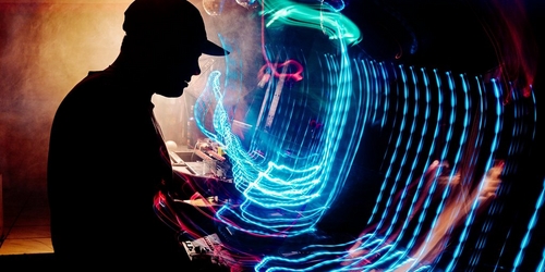 a man is playing a keyboard in a dark room a man is playing a keyboard in a dark room