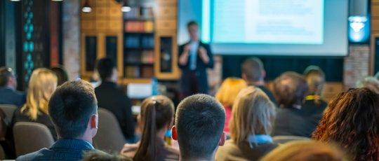 a man is giving a presentation to a group of people
