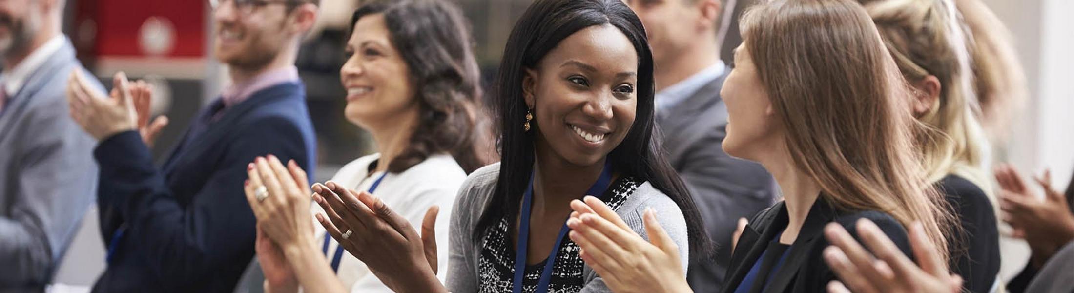 a group of people clapping their hands together in a line