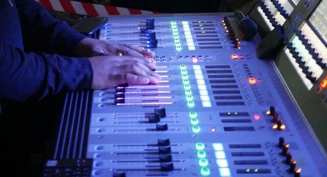 a room with a large yellow chair and a large screen