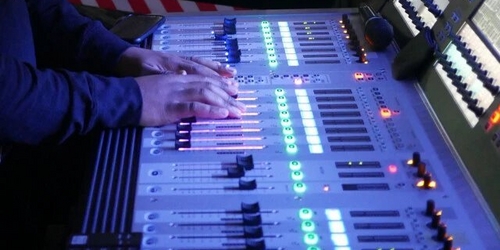 a room with a large yellow chair and a large screen a room with a large yellow chair and a large screen
