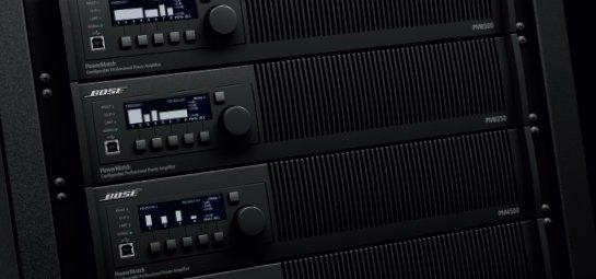 a close up of a rack of audio equipment with a clock on it