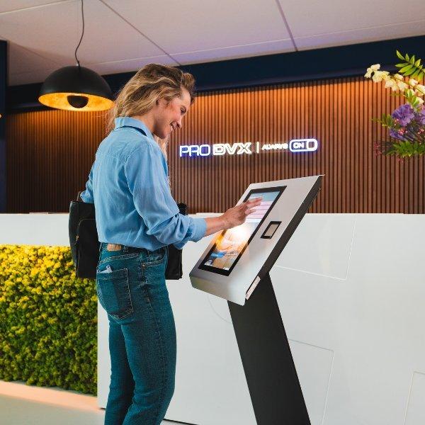woman helping herself in an office via a self service display
