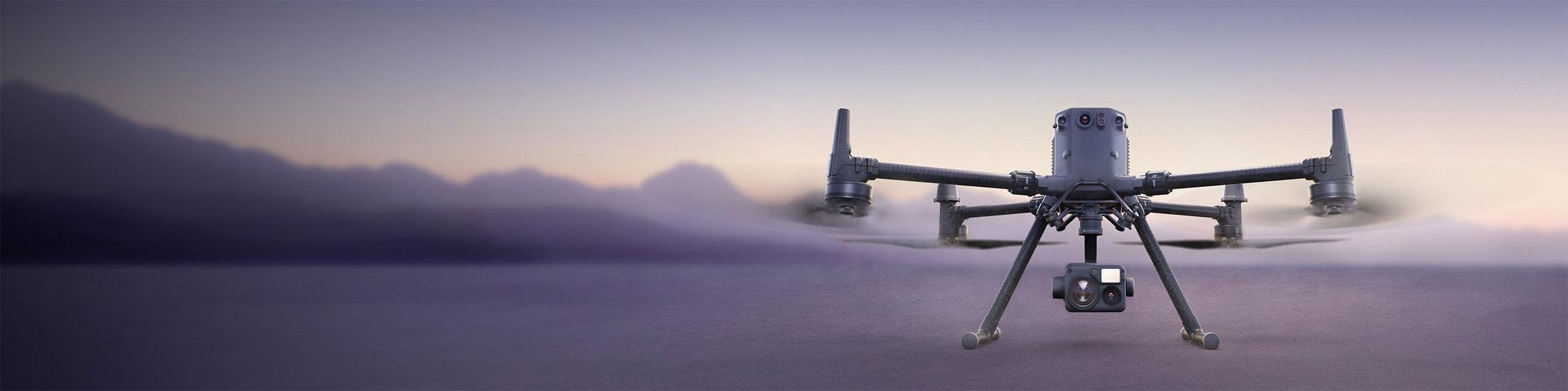 a large drone flying over a body of water with mountains in the background