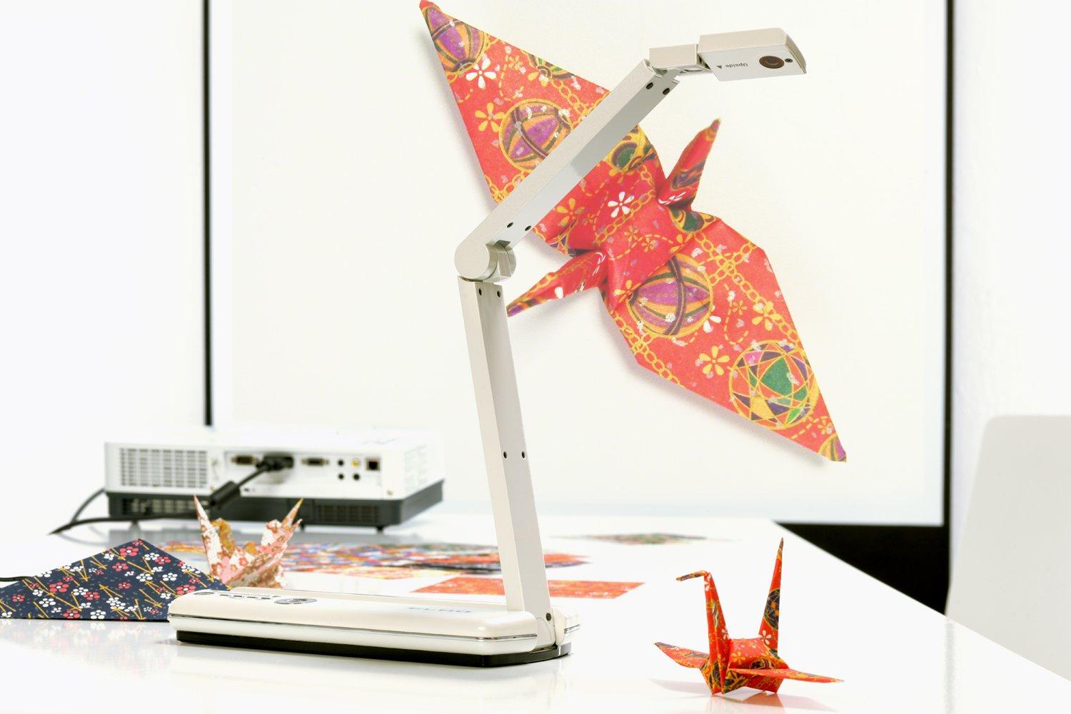 a desk with a lamp and origami paper on it