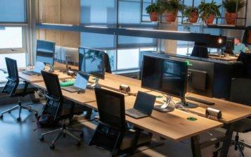 a large open office with a desk and a bunch of computers