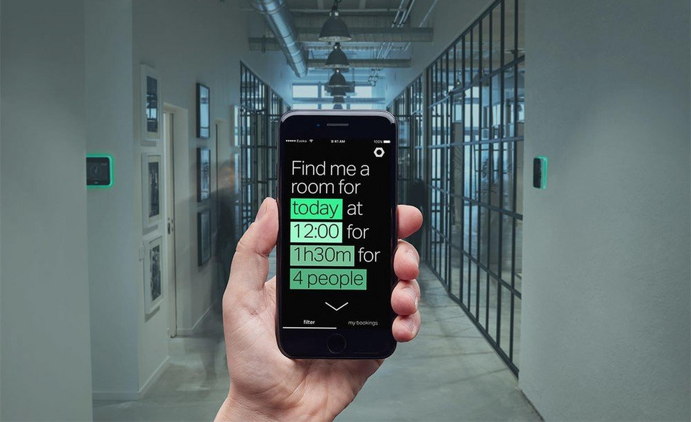 a person holding a cell phone in a hallway with a sign that says "find a room for