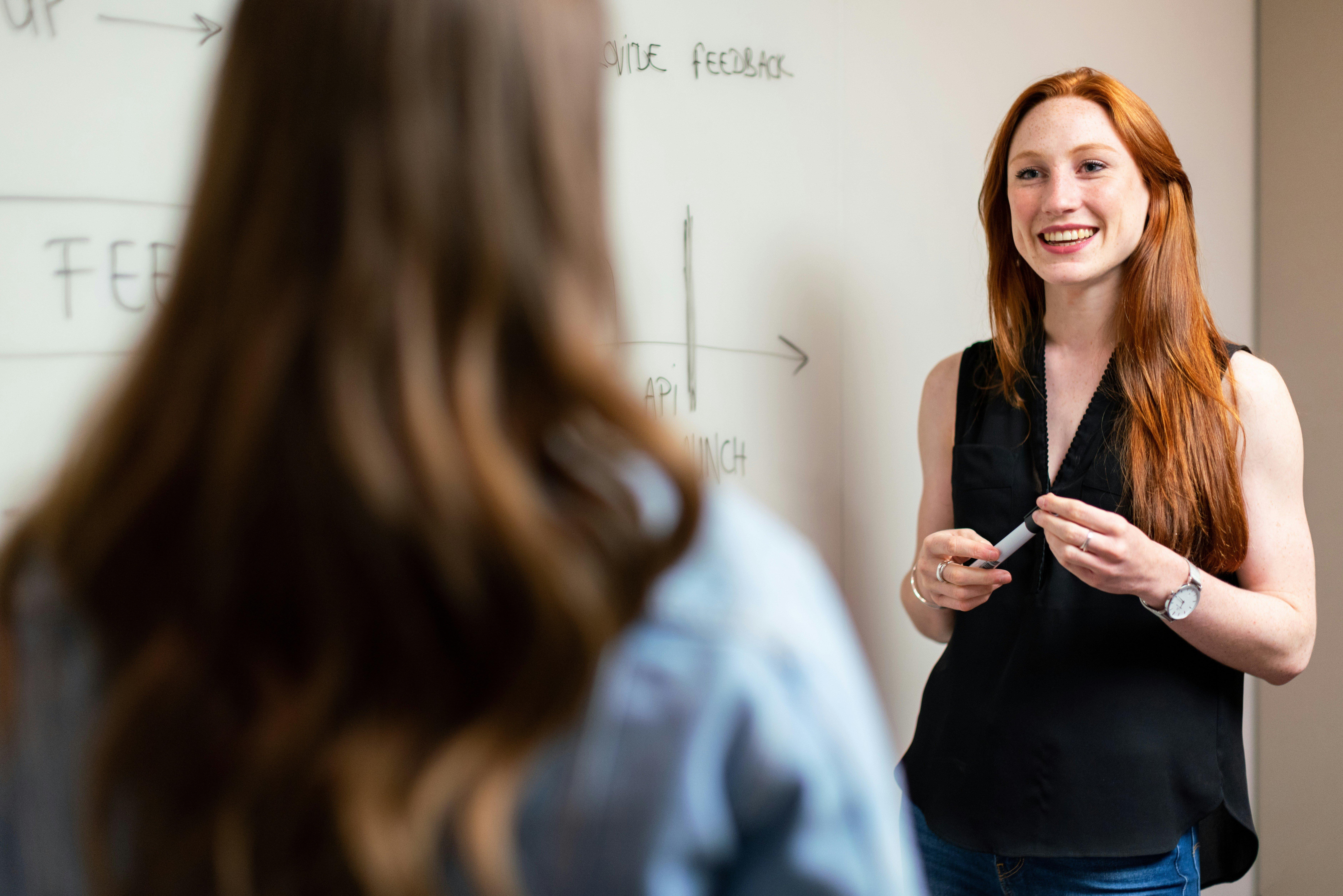 Global Education Stock Imagery Smiling Teacher Woman Whiteboard Discussion Classroom Thisisengineering H6gCRTCxM7o Unsplash RF