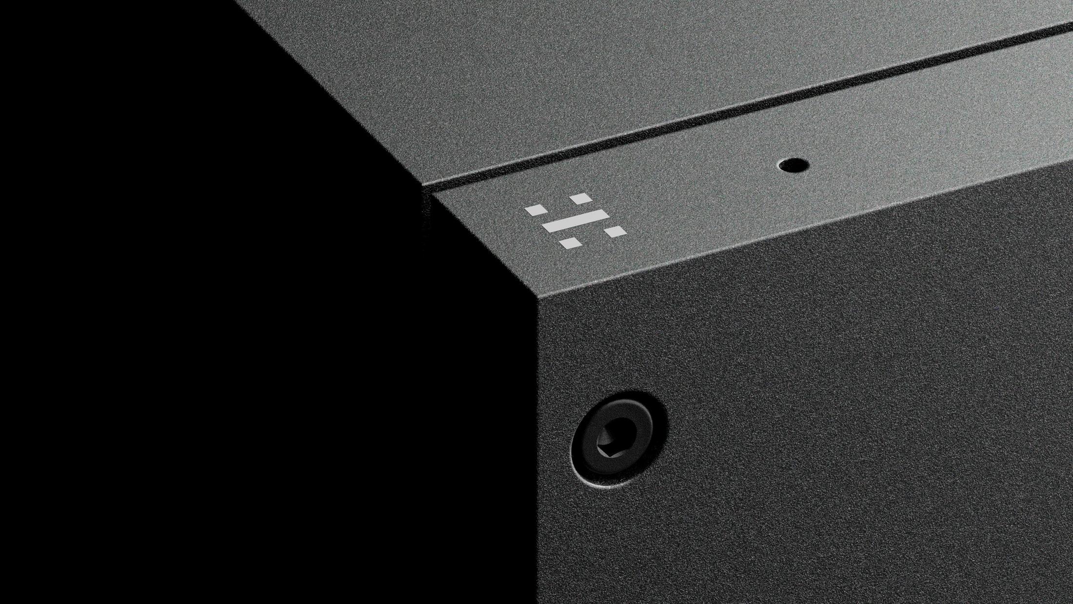 a close up of a black box with a white button on it