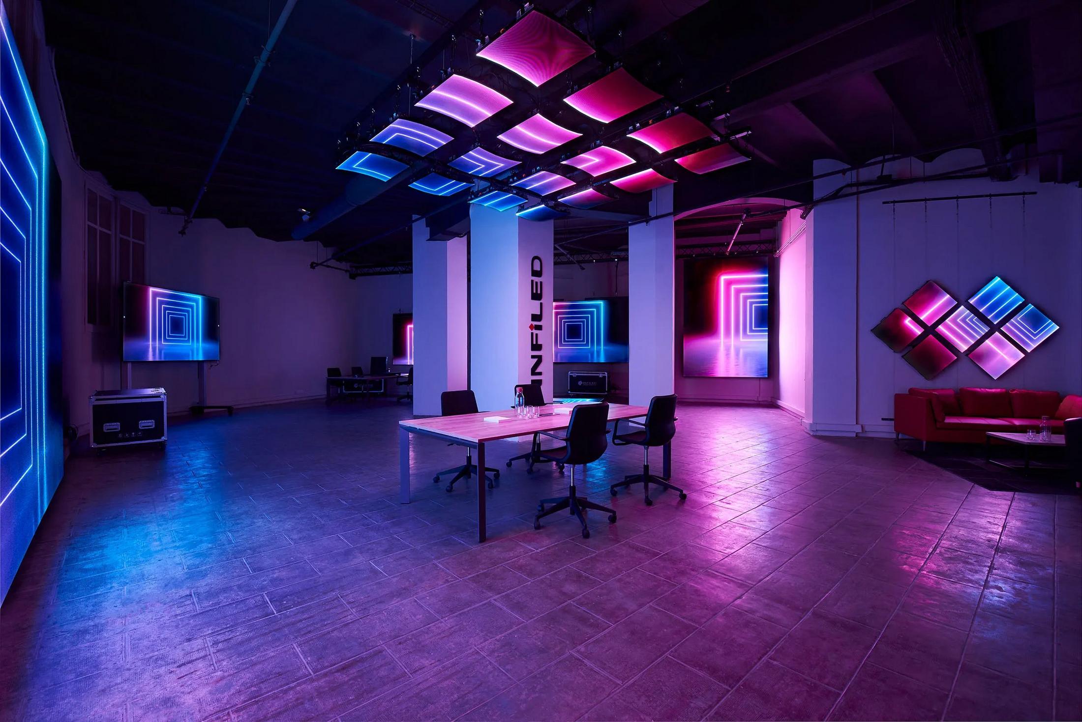 a room with a table and chairs in it and neon lights