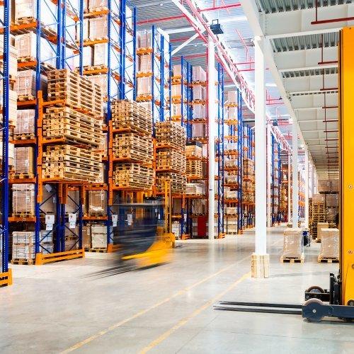 a warehouse with a forklift and a lot of boxes