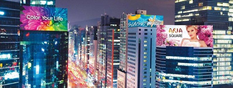 a cityscape with many buildings and billboards at night