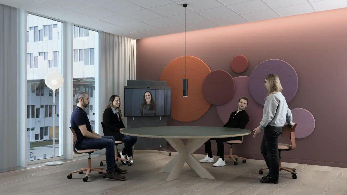 a group of people are sitting around a table in a room