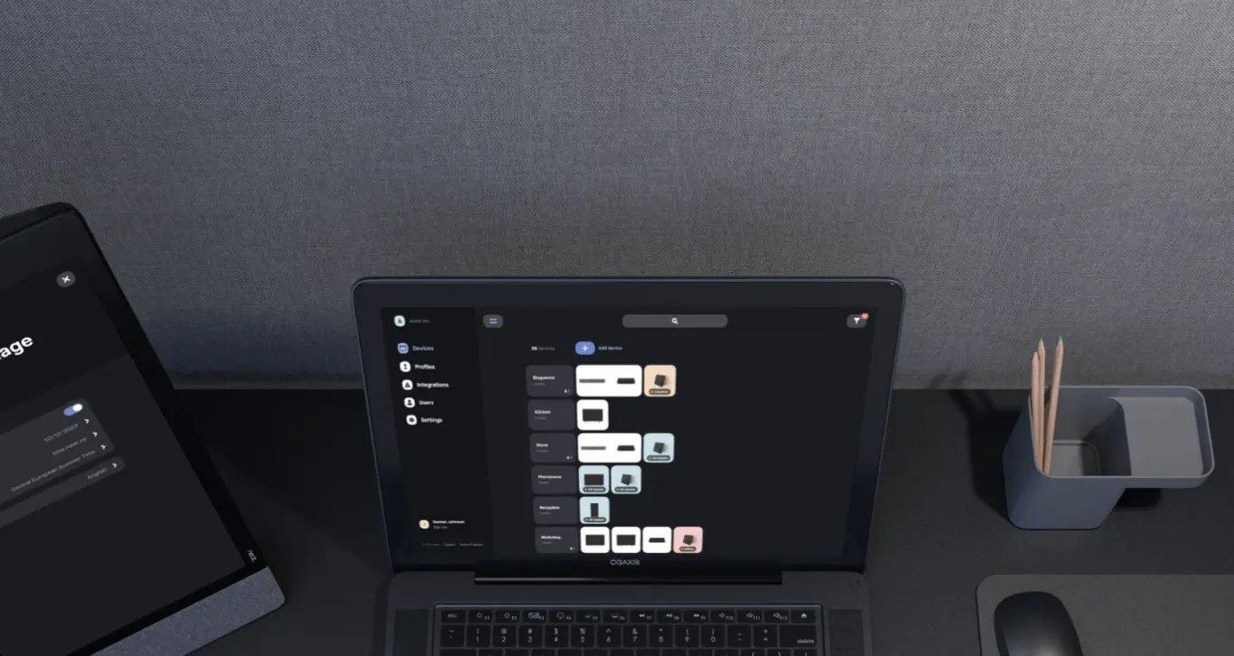 a laptop computer sitting on a desk next to a mouse
