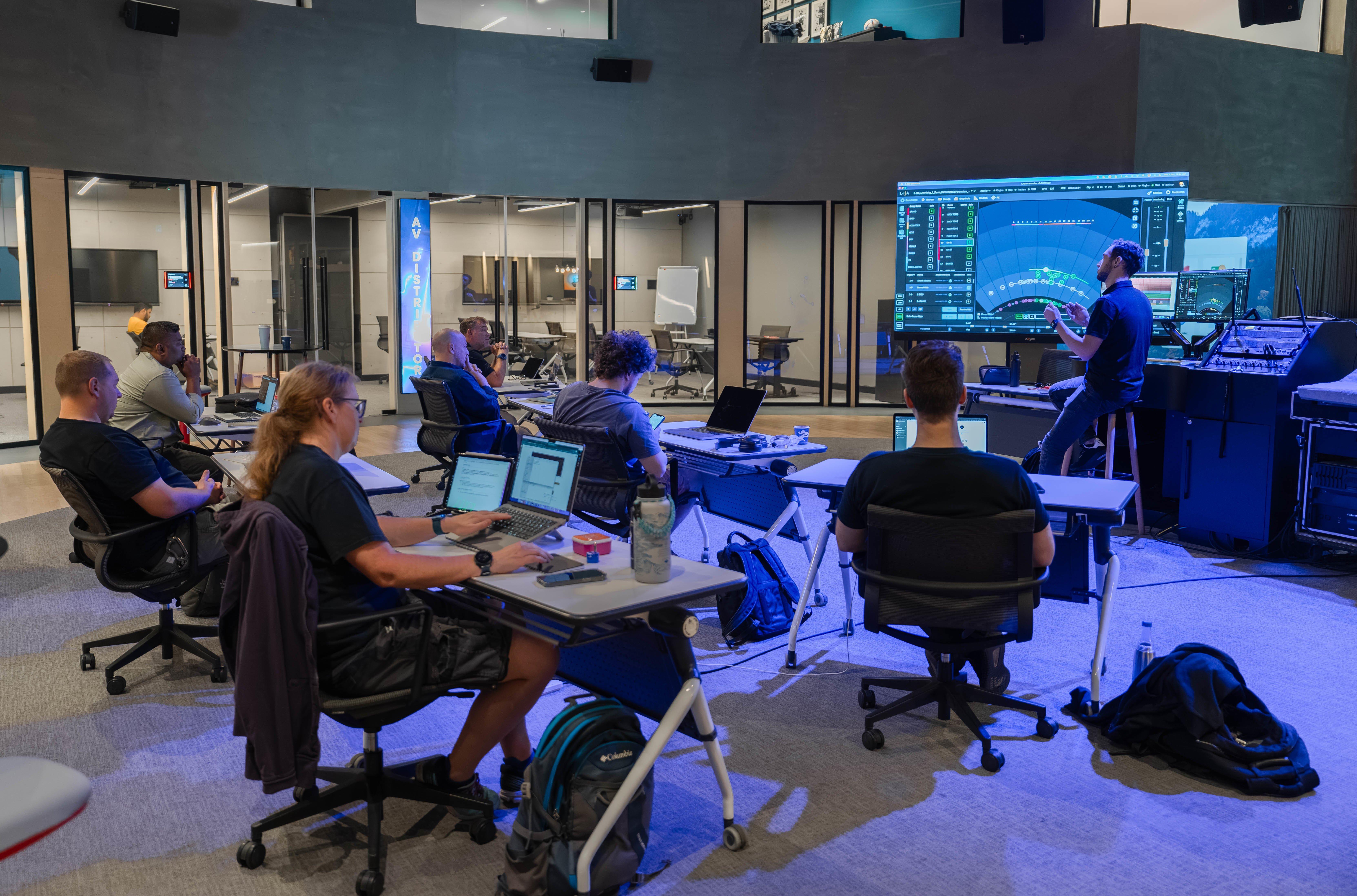 a group of people sitting at computers in a room