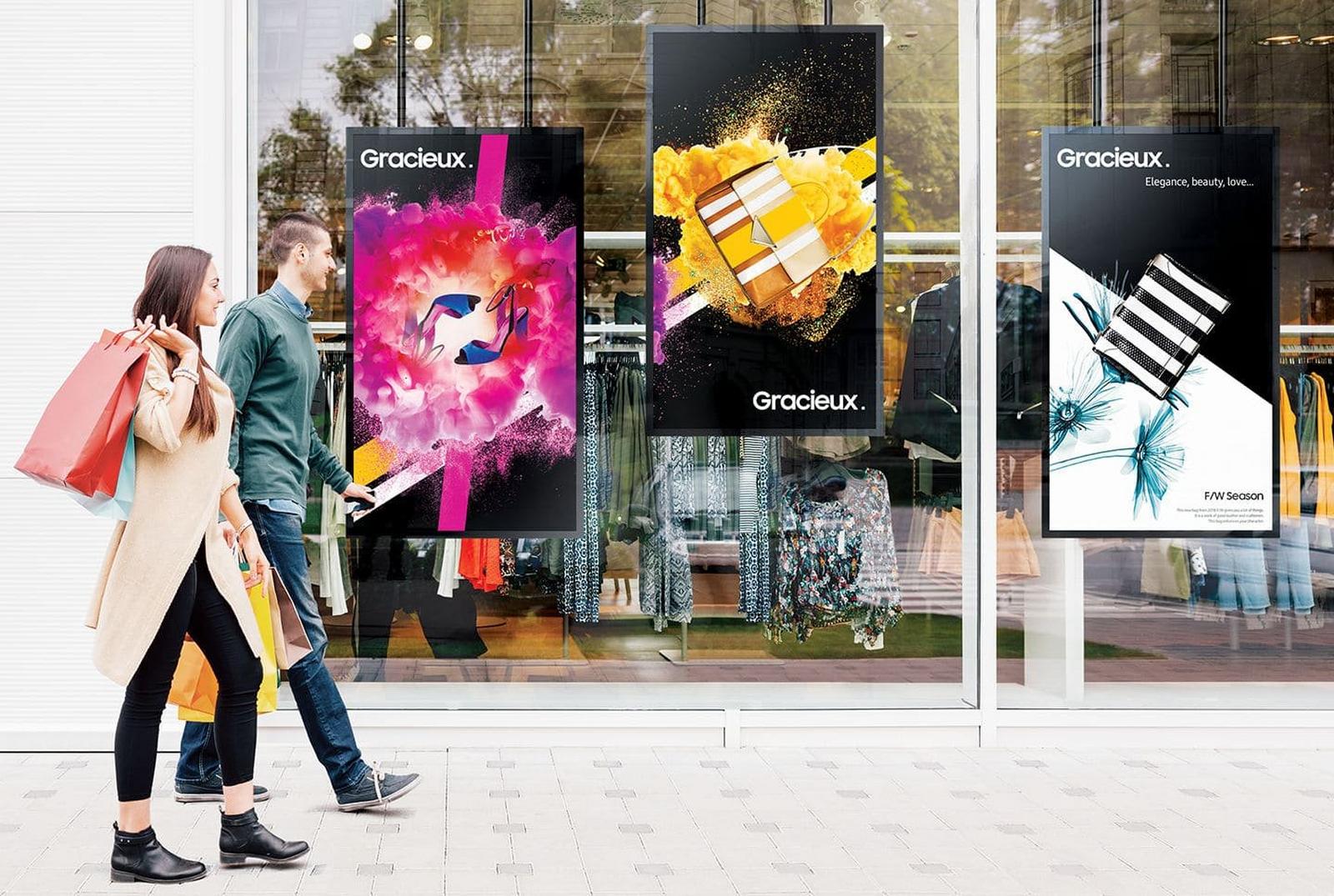 a couple of people walking down a street with shopping bags