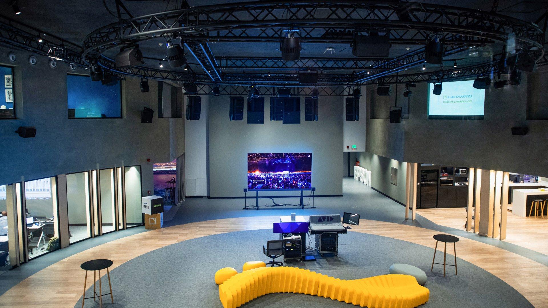 a room with a large yellow chair and a large screen